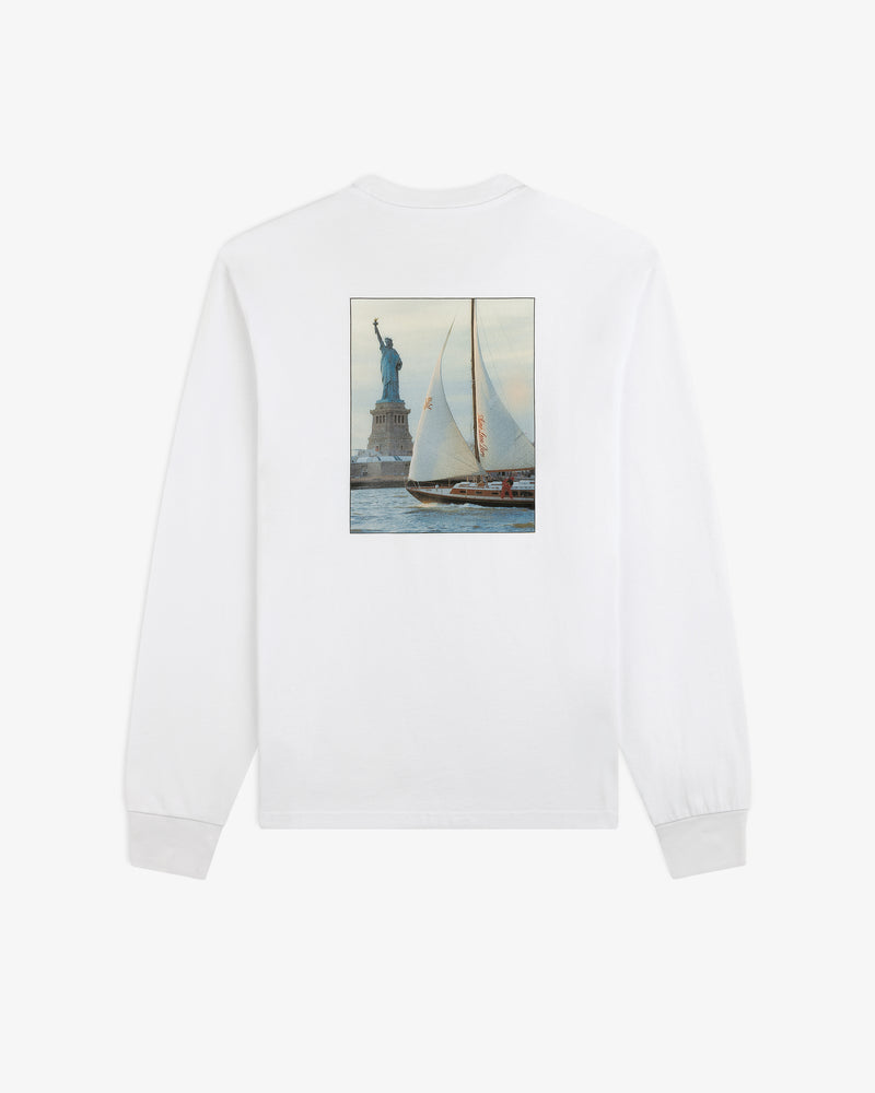 Long-Sleeve Sailing Tee: white long-sleeve shirt with a rectangular back graphic of a sailboat by the Statue of Liberty.