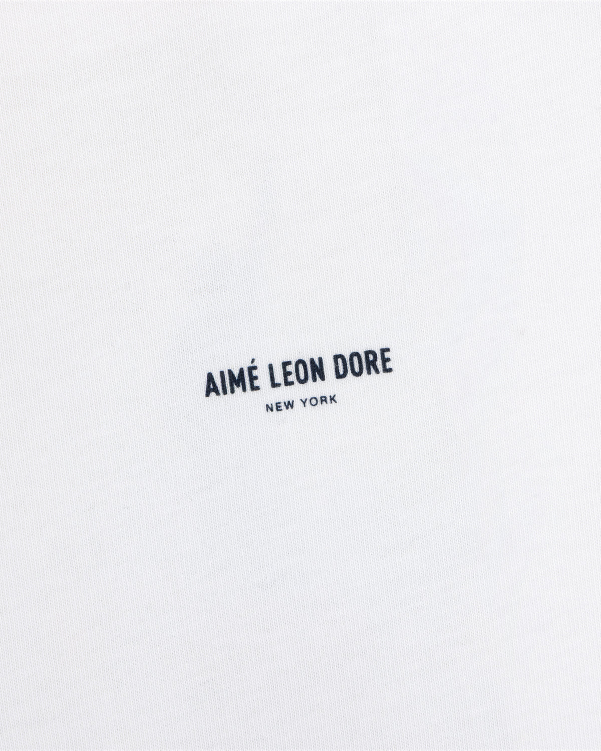 White Long-Sleeve Sailing Tee with black Aimé Leon Dore New York text printed in the center.