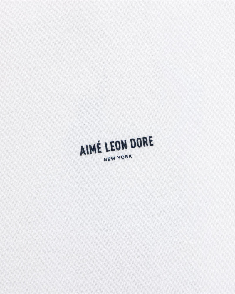 White Long-Sleeve Sailing Tee with black Aimé Leon Dore New York text printed in the center.