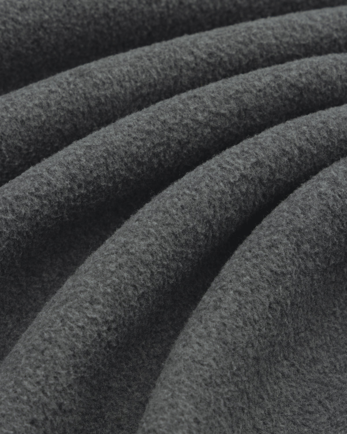 Close-up of Melange Fleece Shirt’s dark gray, textured fabric with soft, wavy folds.