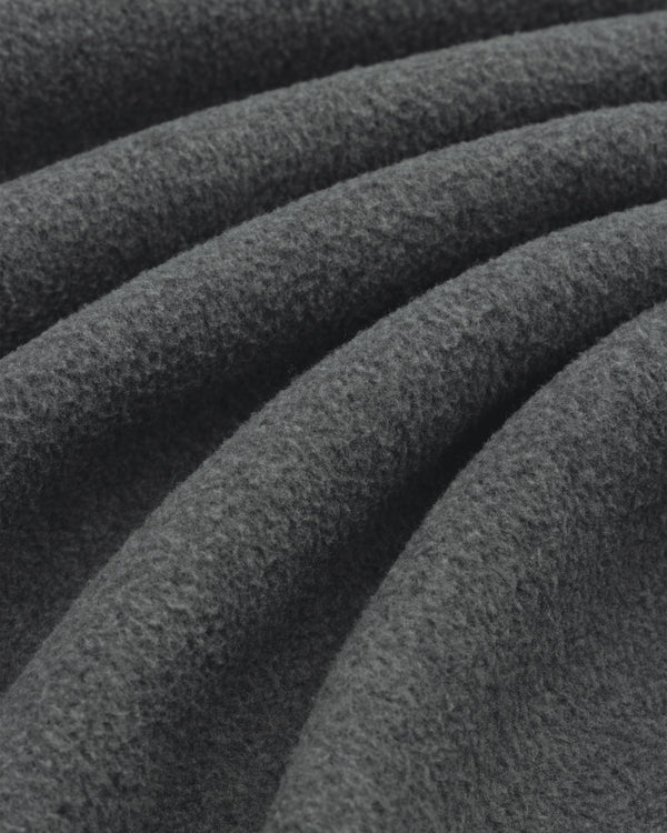 Close-up of Melange Fleece Shirt’s dark gray, textured fabric with soft, wavy folds.