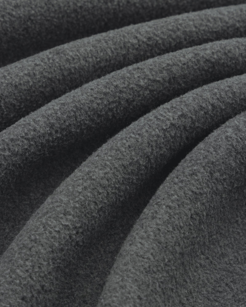 Close-up of Melange Fleece Shirt’s dark gray, textured fabric with soft, wavy folds.