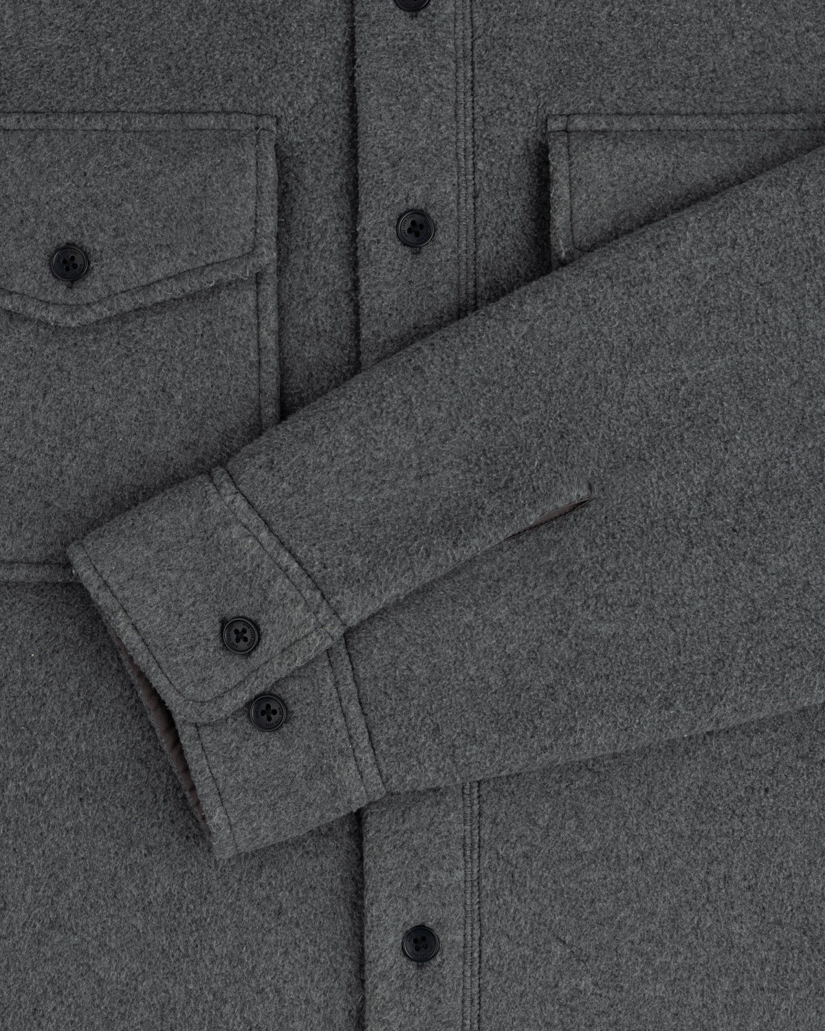 Melange Fleece Shirt: gray wool, black buttons, two chest pockets, sleeve draped diagonally on the front.