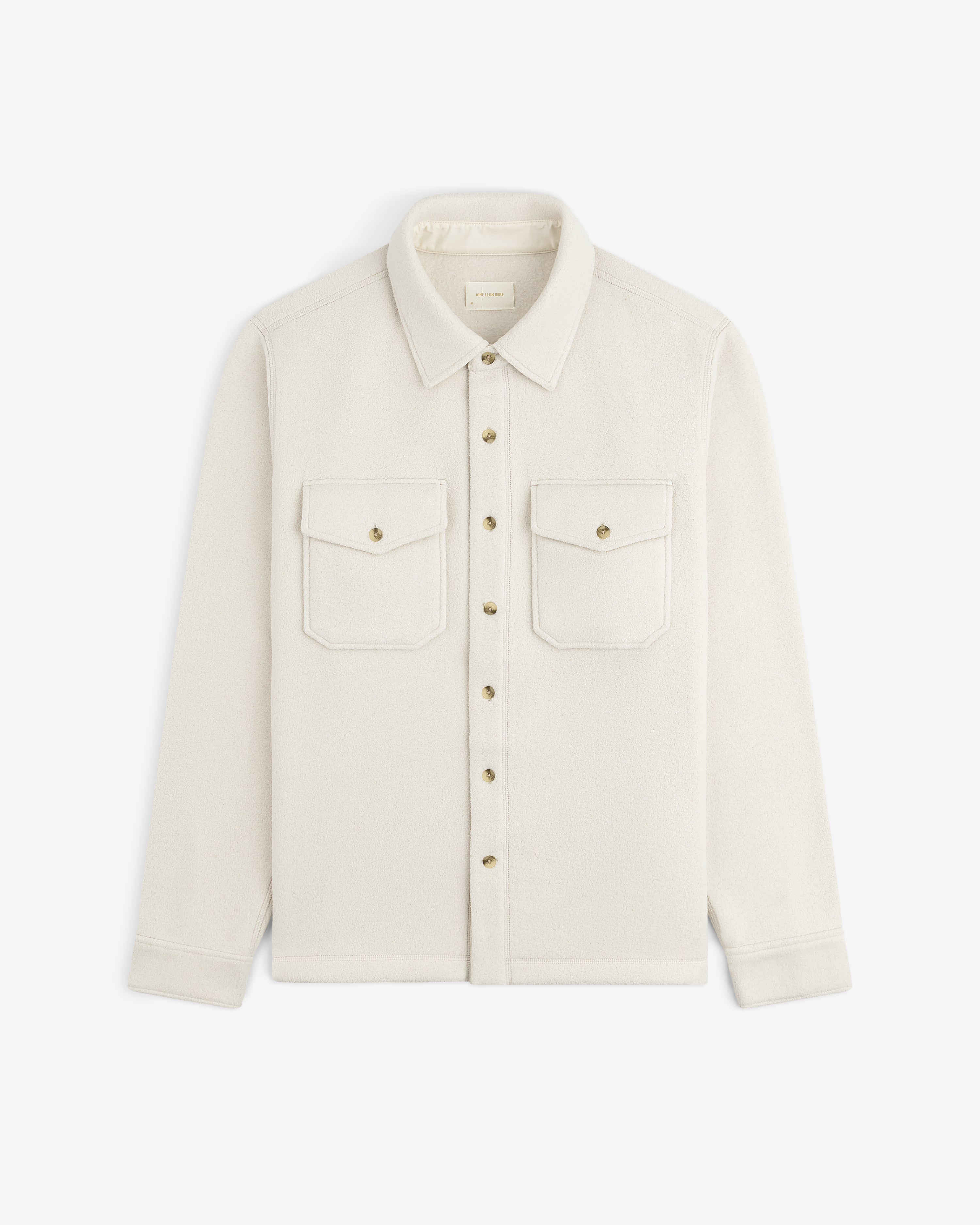 Melange Fleece Shirt in cream with two chest pockets and classic collar, laid flat on a white background.