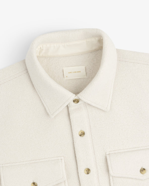 Melange Fleece Shirt in cream with buttons and two front pockets, displayed flat on a white background.