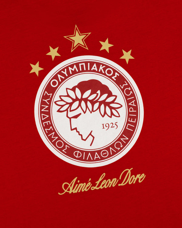 Red ALD / Olympiacos F.C. Souvenir Tee featuring a circular logo, five gold stars, and Aimé Leon Dore text.