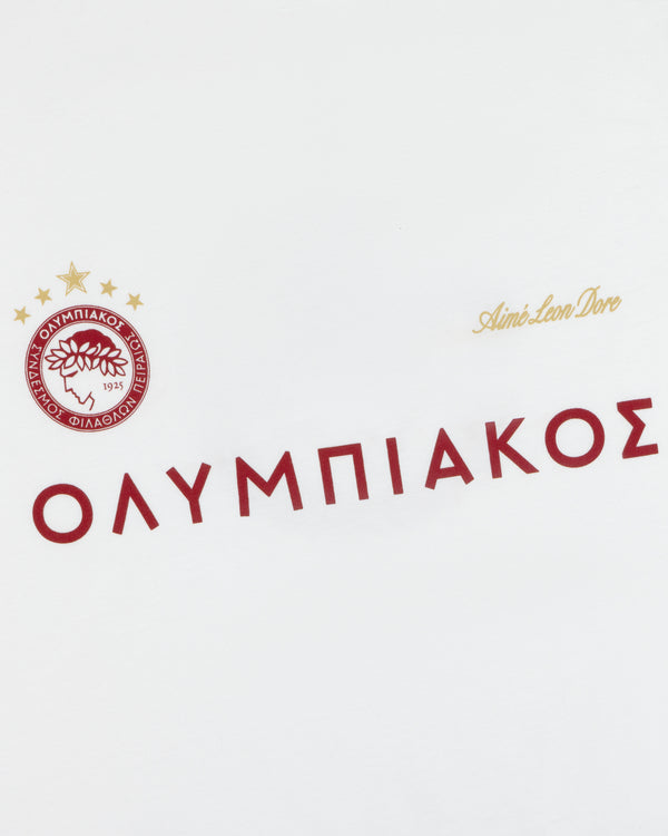 ALD / Olympiacos F.C. Souvenir Tee in white with a red club crest, red Greek text, and gold branding.