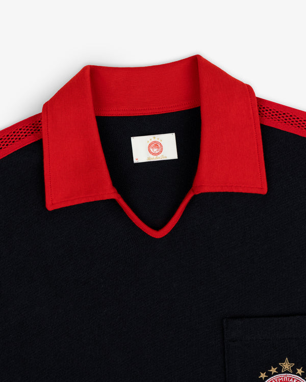 ALD / Olympiacos F.C. Heritage Ringer Polo: black shirt with red collar, mesh shoulders, and gold star chest embroidery.