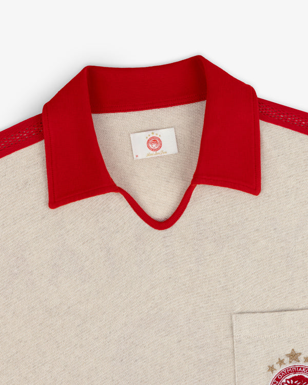 ALD / Olympiacos F.C. Heritage Ringer Polo in off-white with a red collar, mesh shoulder stripes, and chest pocket emblem.