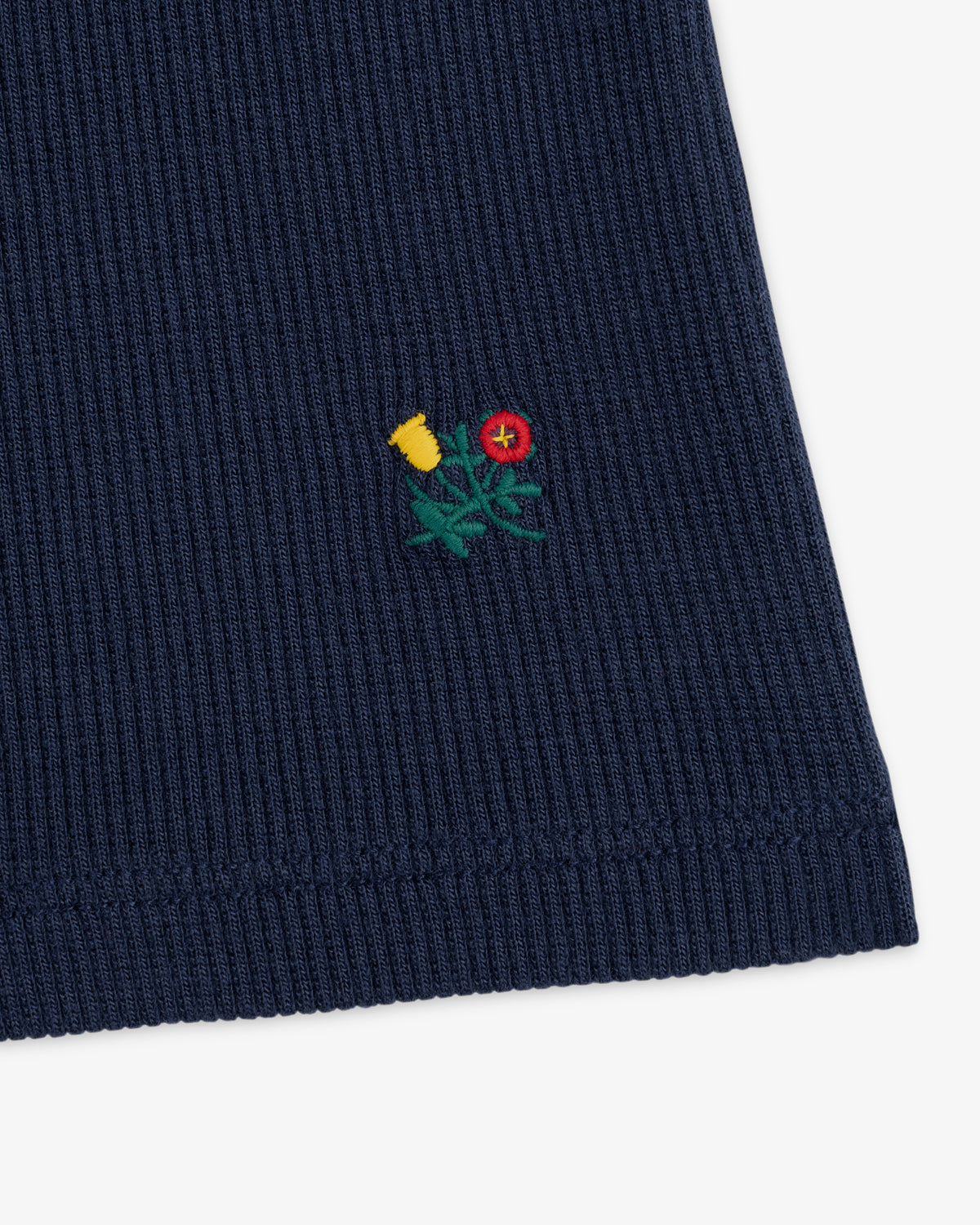 Navy Ribbed Mockneck Long-Sleeve Tee with a small embroidered yellow and red flower design.