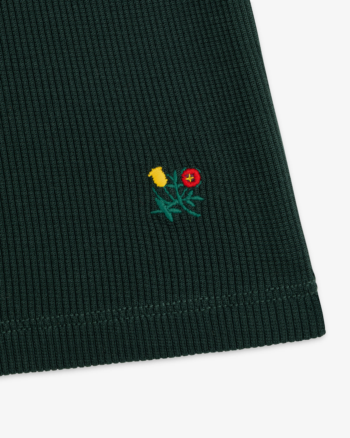 Dark green ribbed Ribbed Mockneck Long-Sleeve Tee with a small embroidered yellow and red floral design.