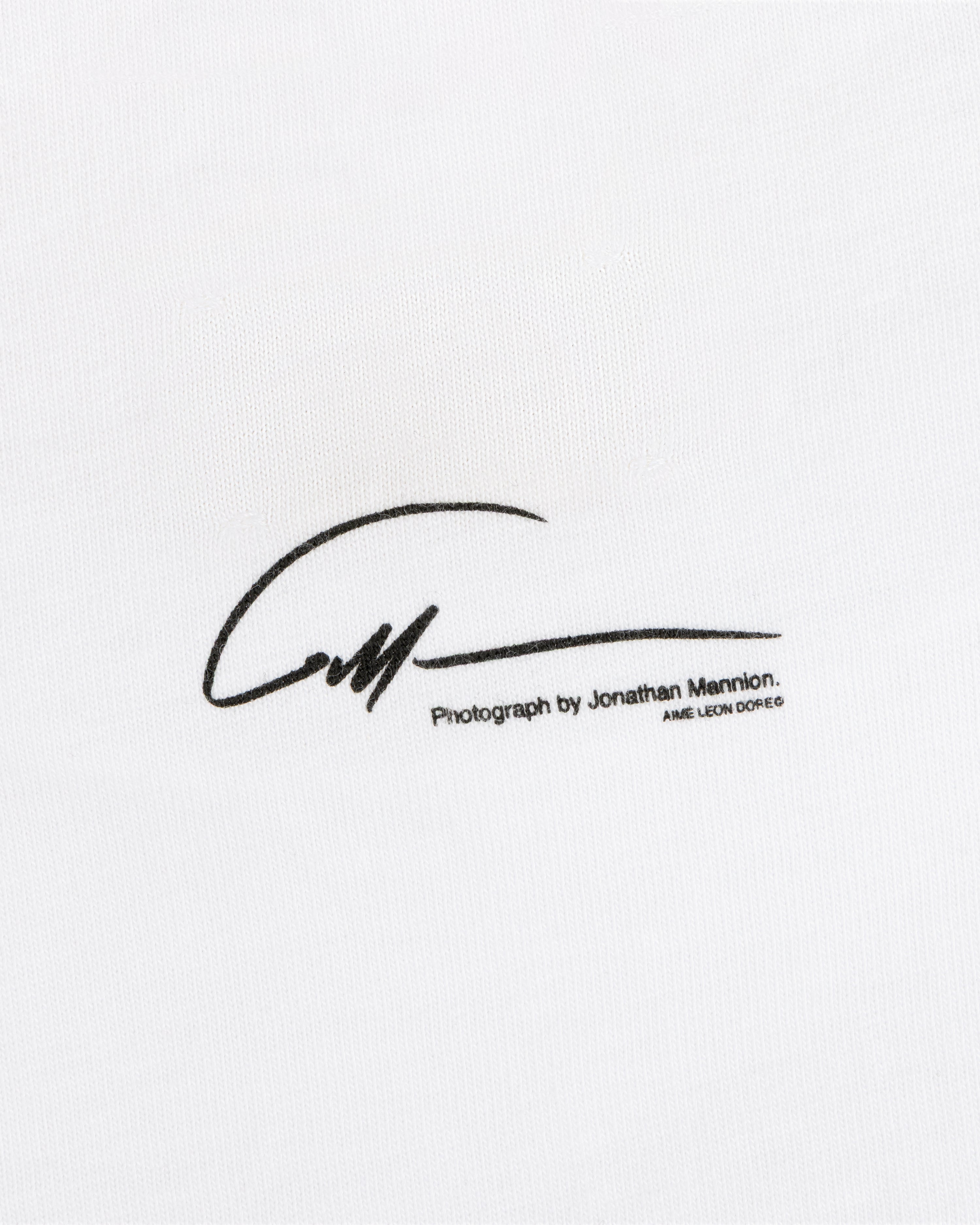 A signature graphic above the text Photograph by Jonathan Mannion on white The Esco Tee fabric.