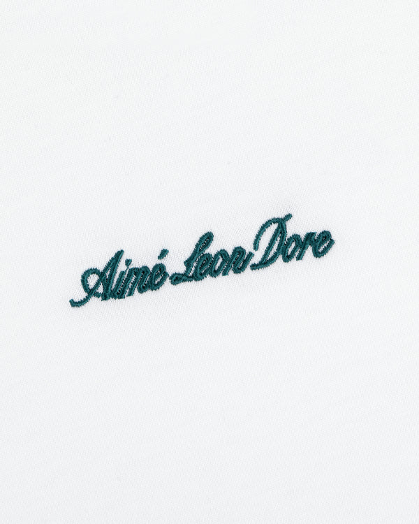 White Shrunken Script Tee featuring dark green cursive embroidery of Aimé Leon Dore centered on the chest.