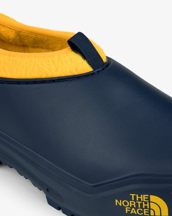 ALD / The North Face Base Camp Mule in navy with yellow lining and side logo, shown close-up.
