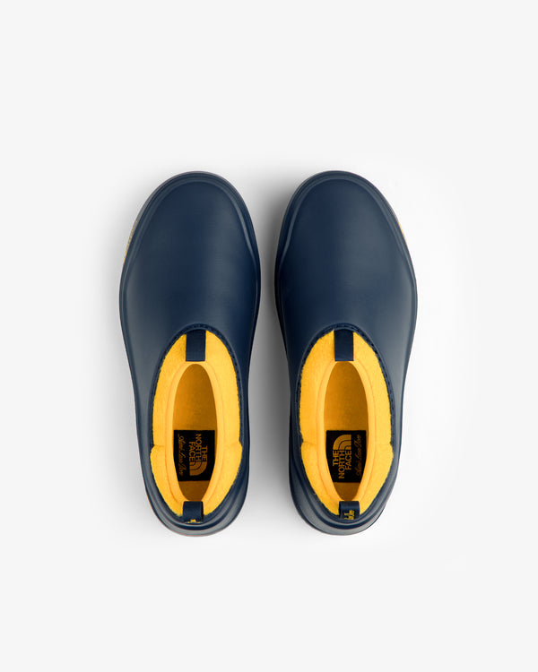 Top view of ALD / The North Face Base Camp Mule in blue with yellow interior on a white background.