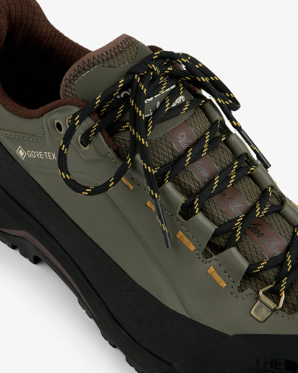 ALD/The North Face Verto Alpine Gore-Tex hiking shoe: olive green with black-yellow laces, brown accents, white base.