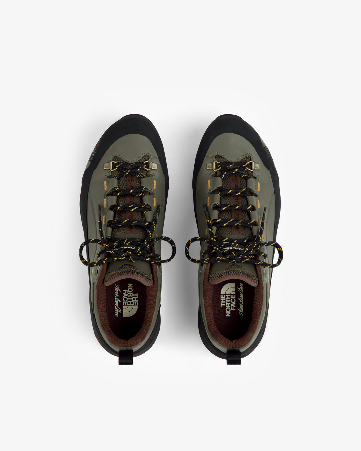 Green and black ALD/The North Face Verto Alpine GORE-TEX hiking shoes with yellow-black laces on white.
