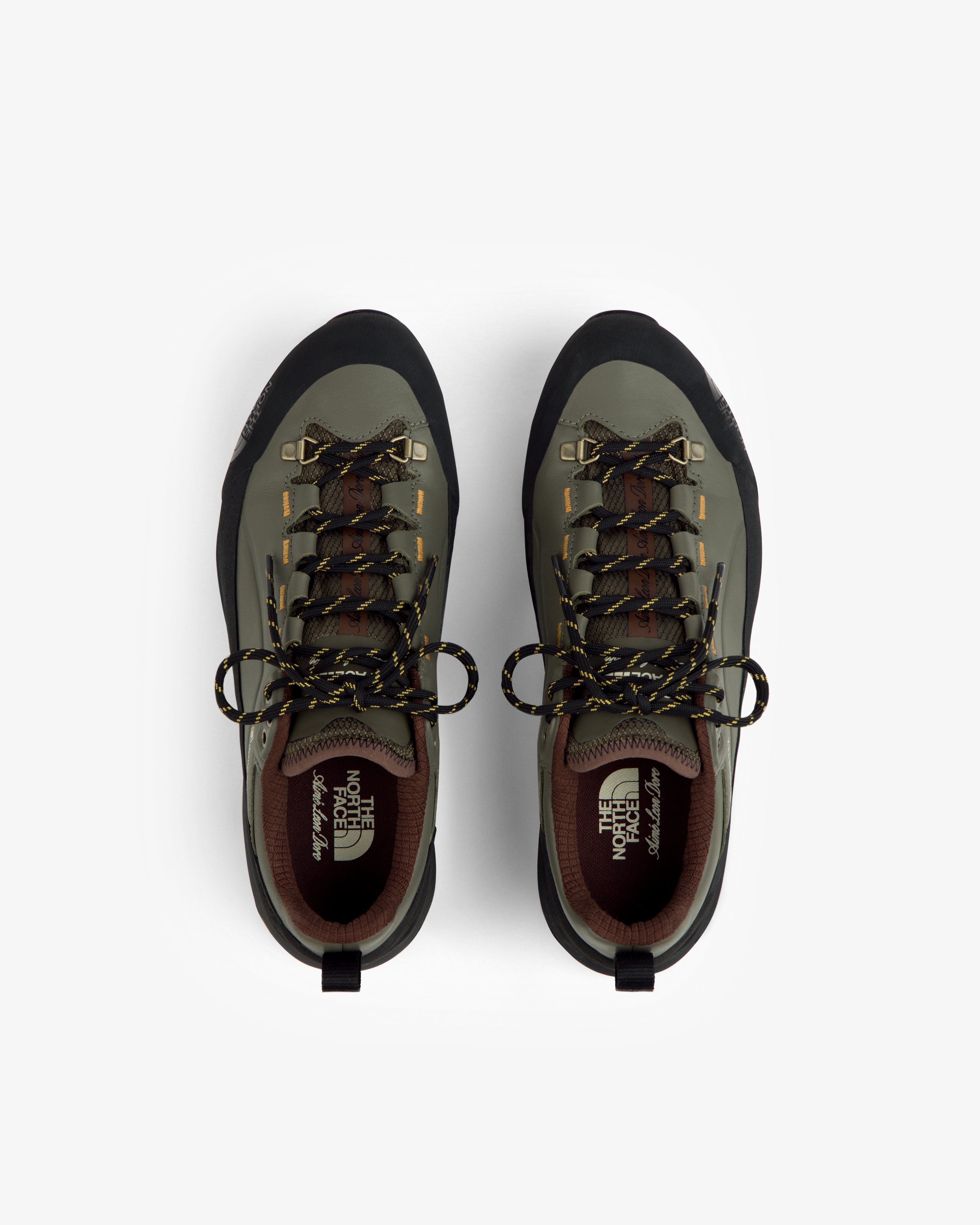 Green and black ALD/The North Face Verto Alpine GORE-TEX hiking shoes with yellow-black laces on white.