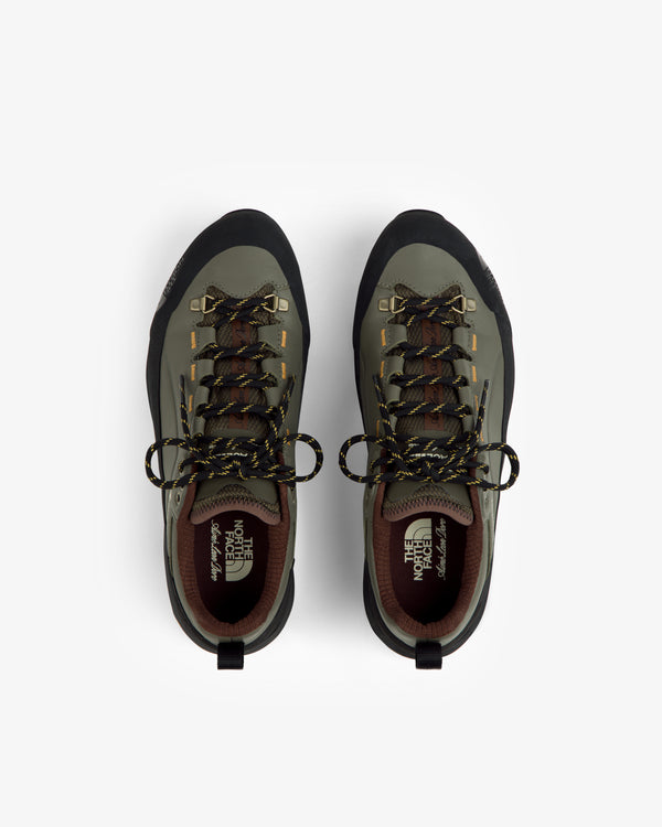 Green and black ALD/The North Face Verto Alpine GORE-TEX hiking shoes with yellow-black laces on white.