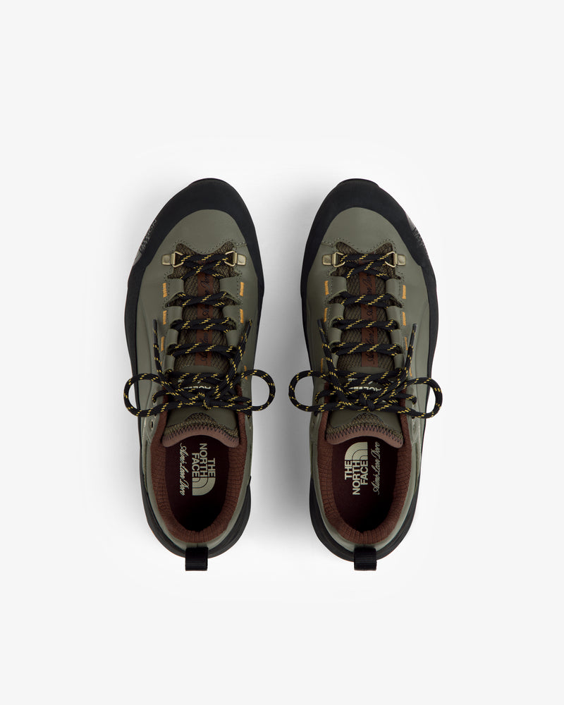 Green and black ALD/The North Face Verto Alpine GORE-TEX hiking shoes with yellow-black laces on white.