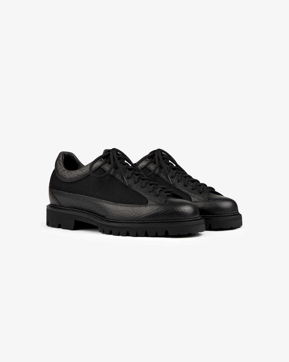 Field Boot black lace-up boots with a textured leather upper and thick lugged rubber soles.