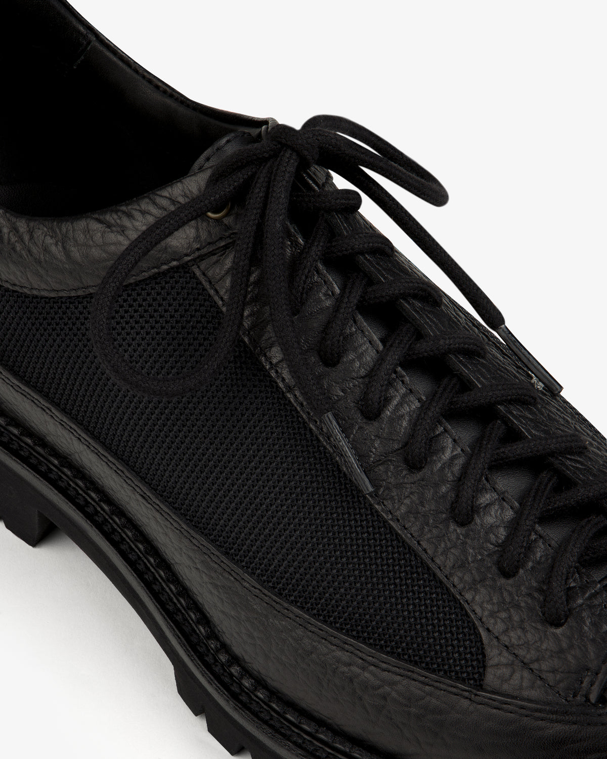 Field Boot in black leather and mesh with a lugged rubber sole and lace-up closure.