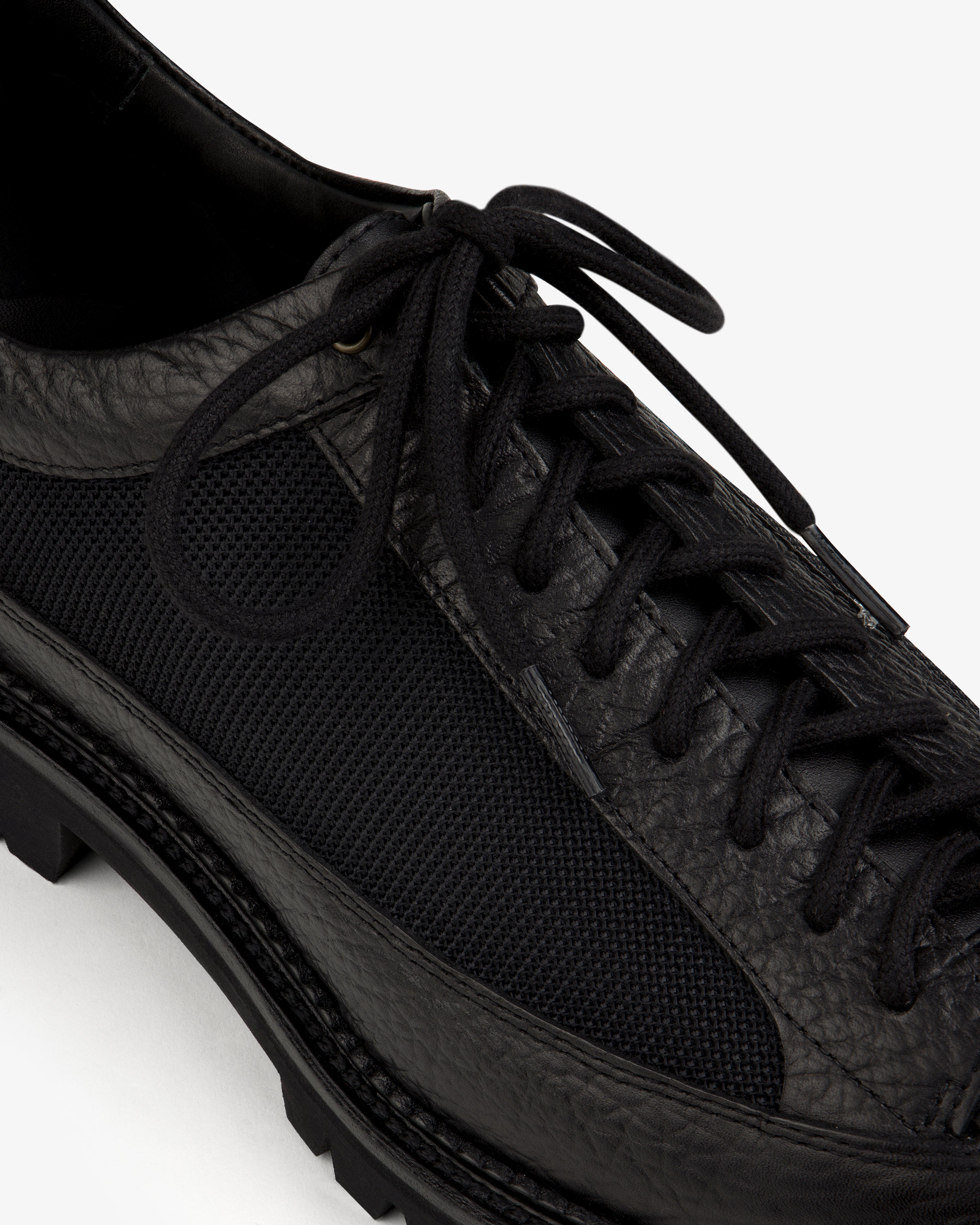 Field Boot in black leather and mesh with a lugged rubber sole and lace-up closure.