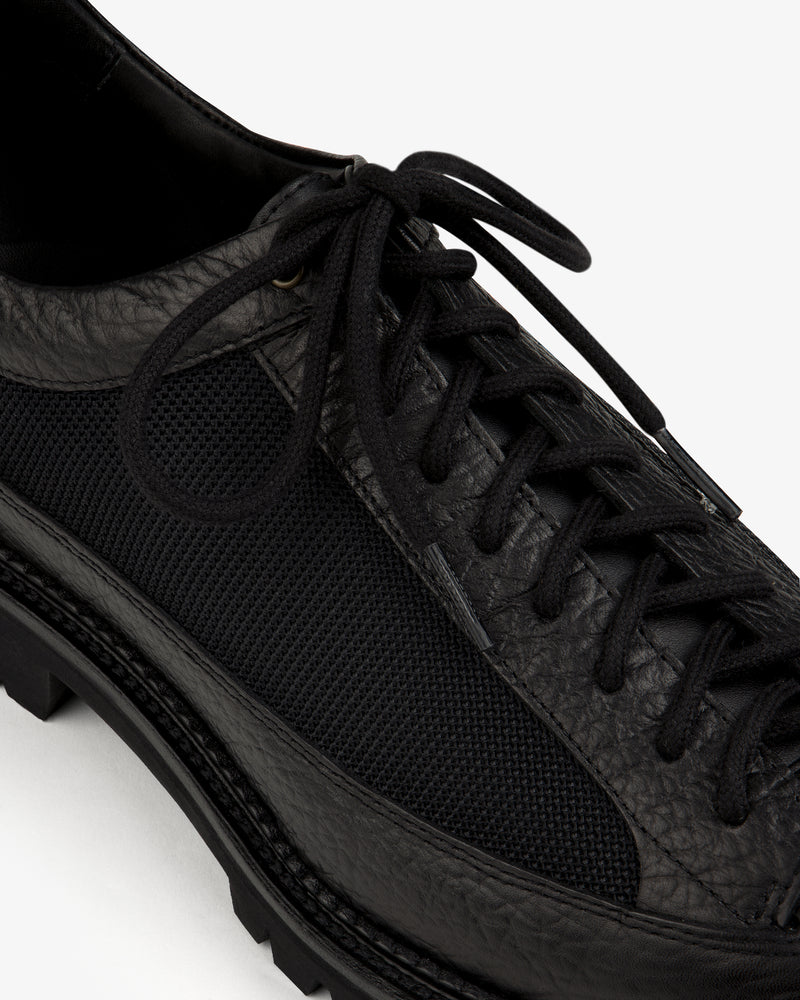 Field Boot in black leather and mesh with a lugged rubber sole and lace-up closure.