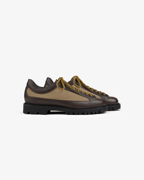 Field Boot in brown with olive canvas side panels, tan laces, and a thick black lug sole.