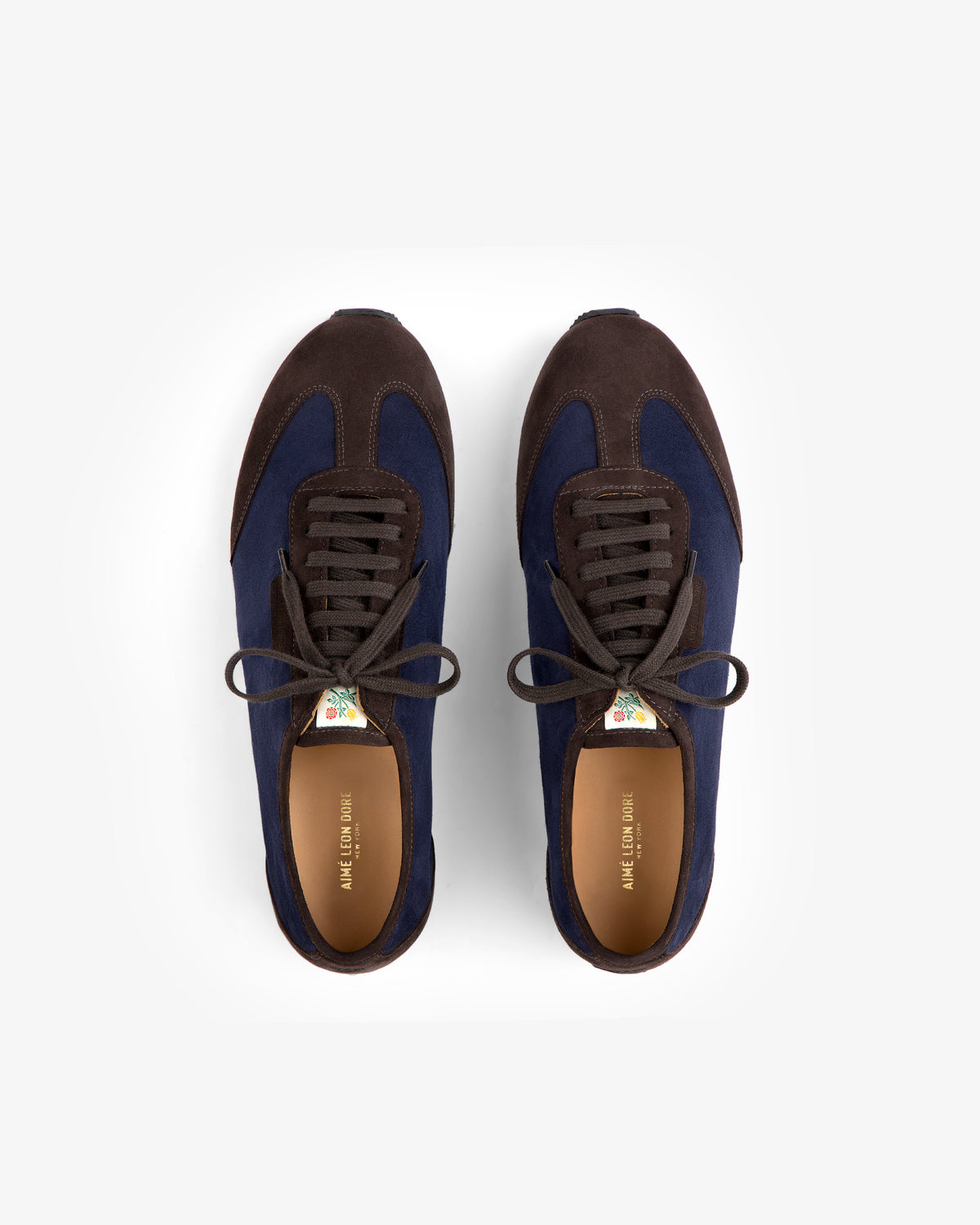 Low Profile Suede Trainer in dark blue and brown with brown laces and floral tongue tags.