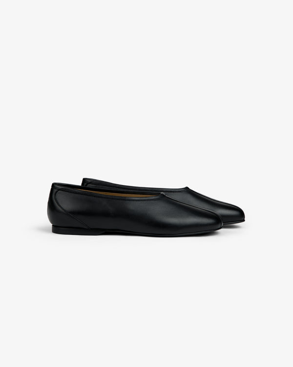 Side view of a pair of black Leather Ballet Flat shoes.