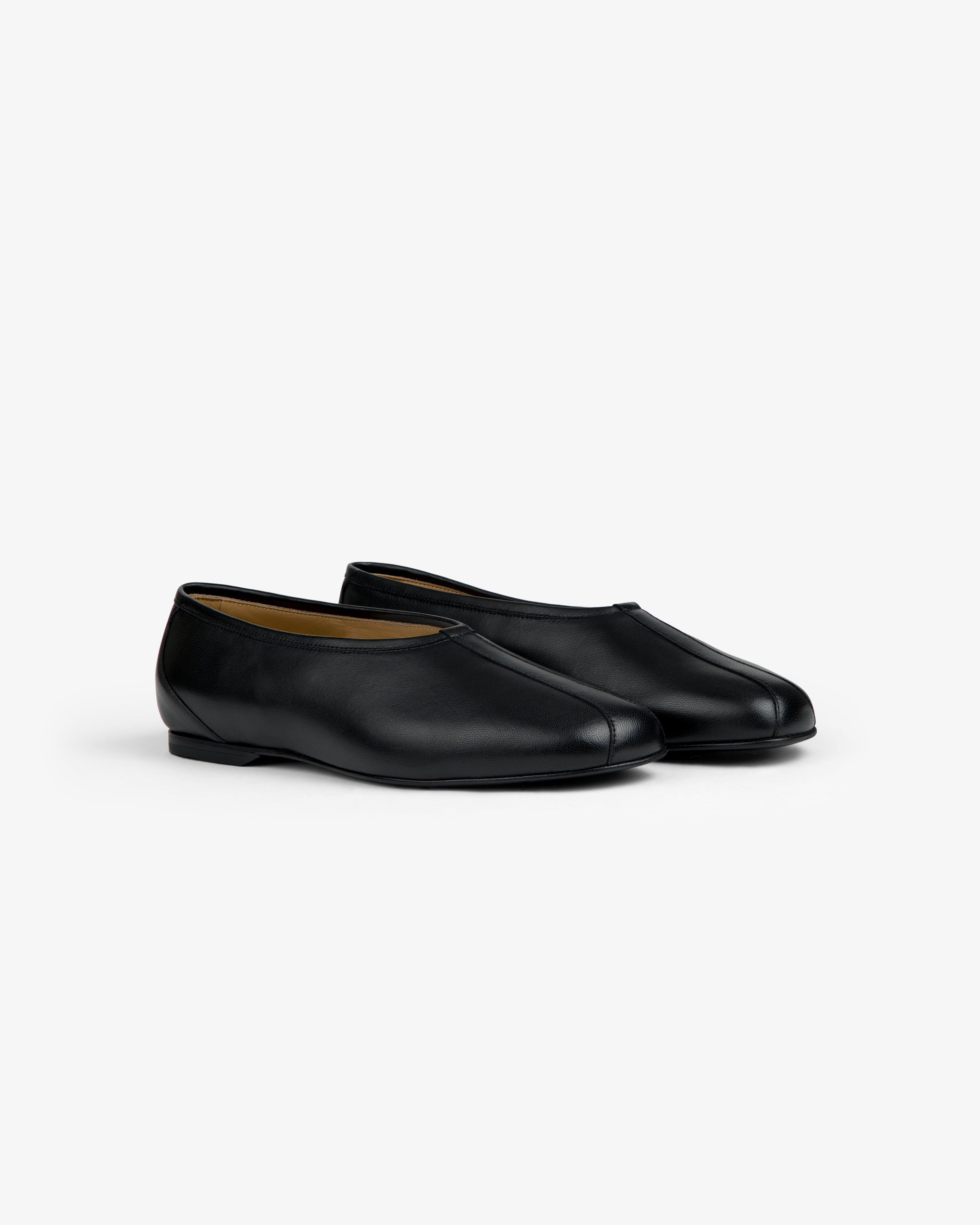 Leather Ballet Flat, a pair of black flats with a rounded toe and a low heel.