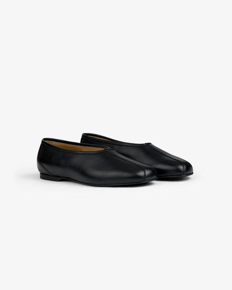 Leather Ballet Flat, a pair of black flats with a rounded toe and a low heel.