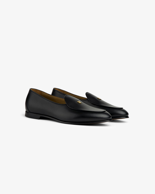 Crest Salóni Loafer in black leather with gold bee detail, displayed at an angle on a white background.