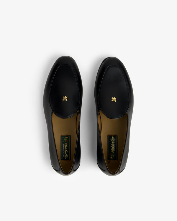 Crest Salóni Loafers—black leather, gold emblems on uppers, photographed from above on a white background.