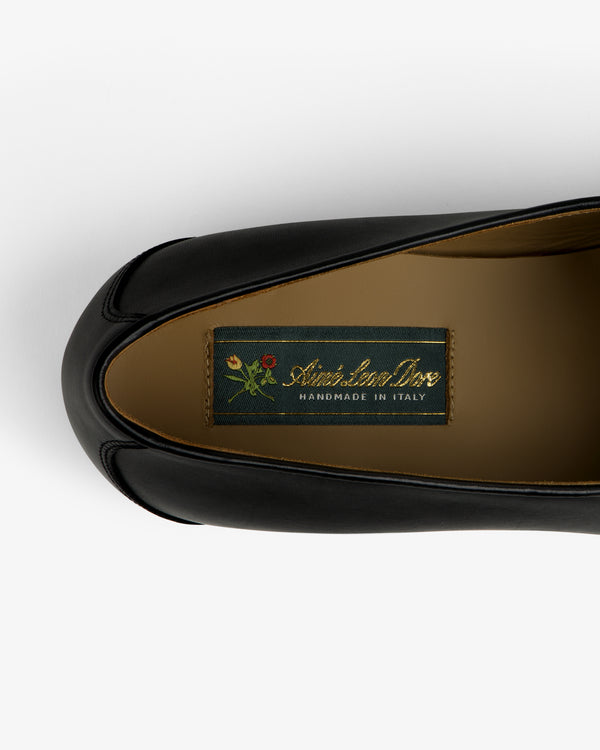 Crest Salóni Loafer: Black leather shoe, “Christian Dior Handmade in Italy” label, small floral graphic inside.