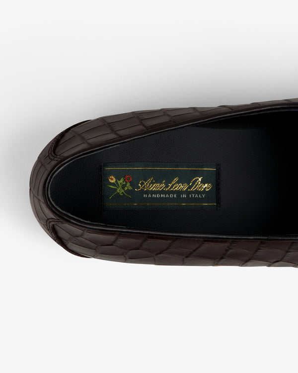 Brown croc-embossed Crest Salóni loafer with small floral detail, labeled Sidonie Larizzi, Handmade in Italy.