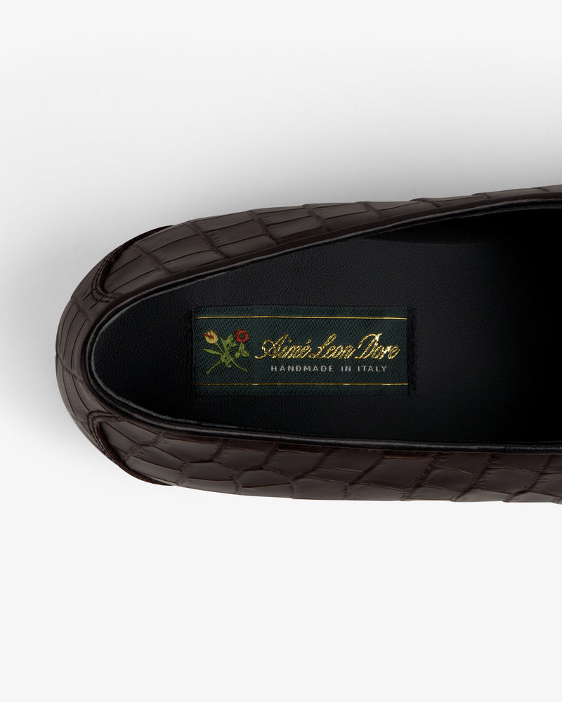 Brown croc-embossed Crest Salóni loafer with small floral detail, labeled Sidonie Larizzi, Handmade in Italy.
