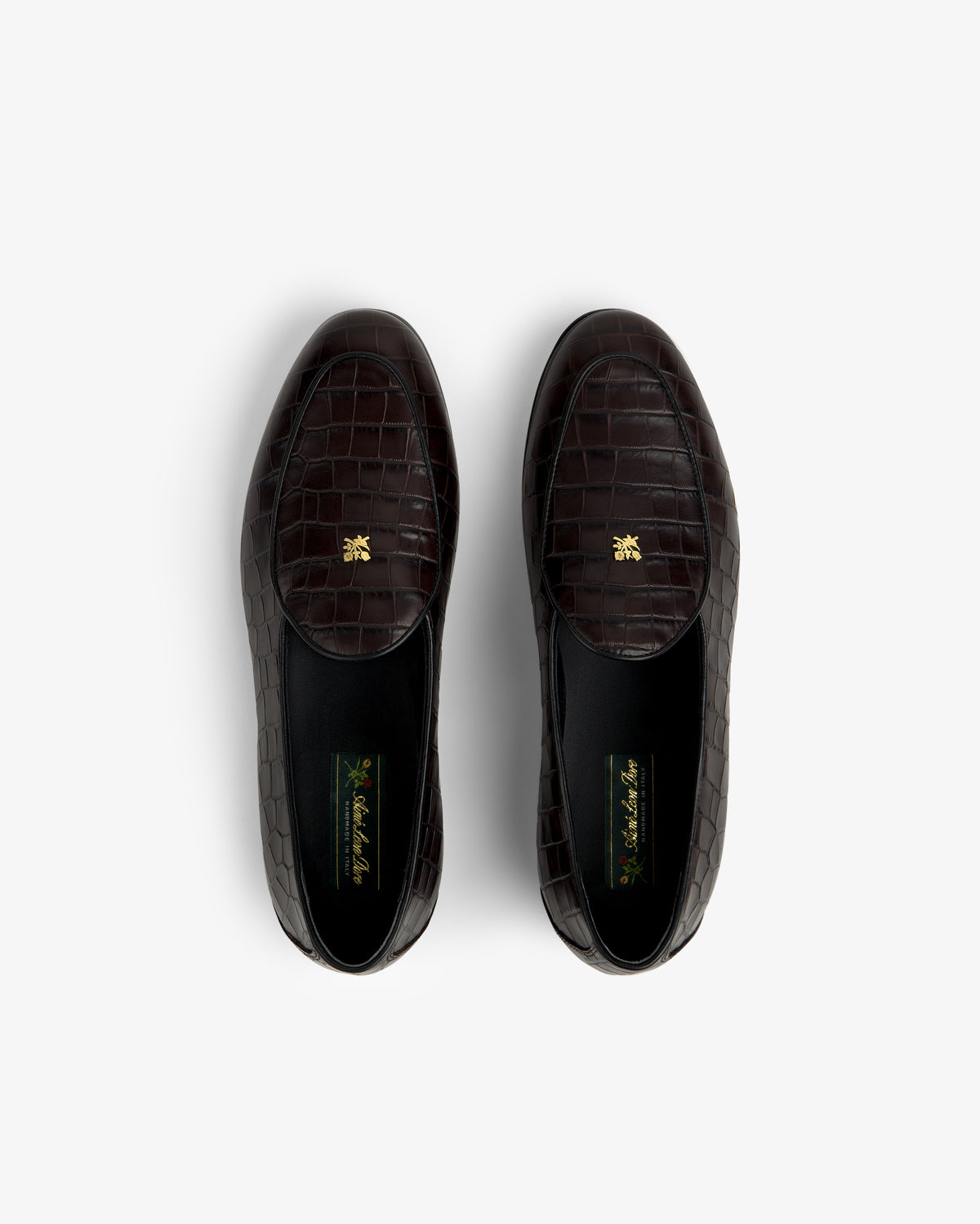 Top view of Croc-Embossed Crest Salóni Loafers in dark brown with gold emblems on the insoles.