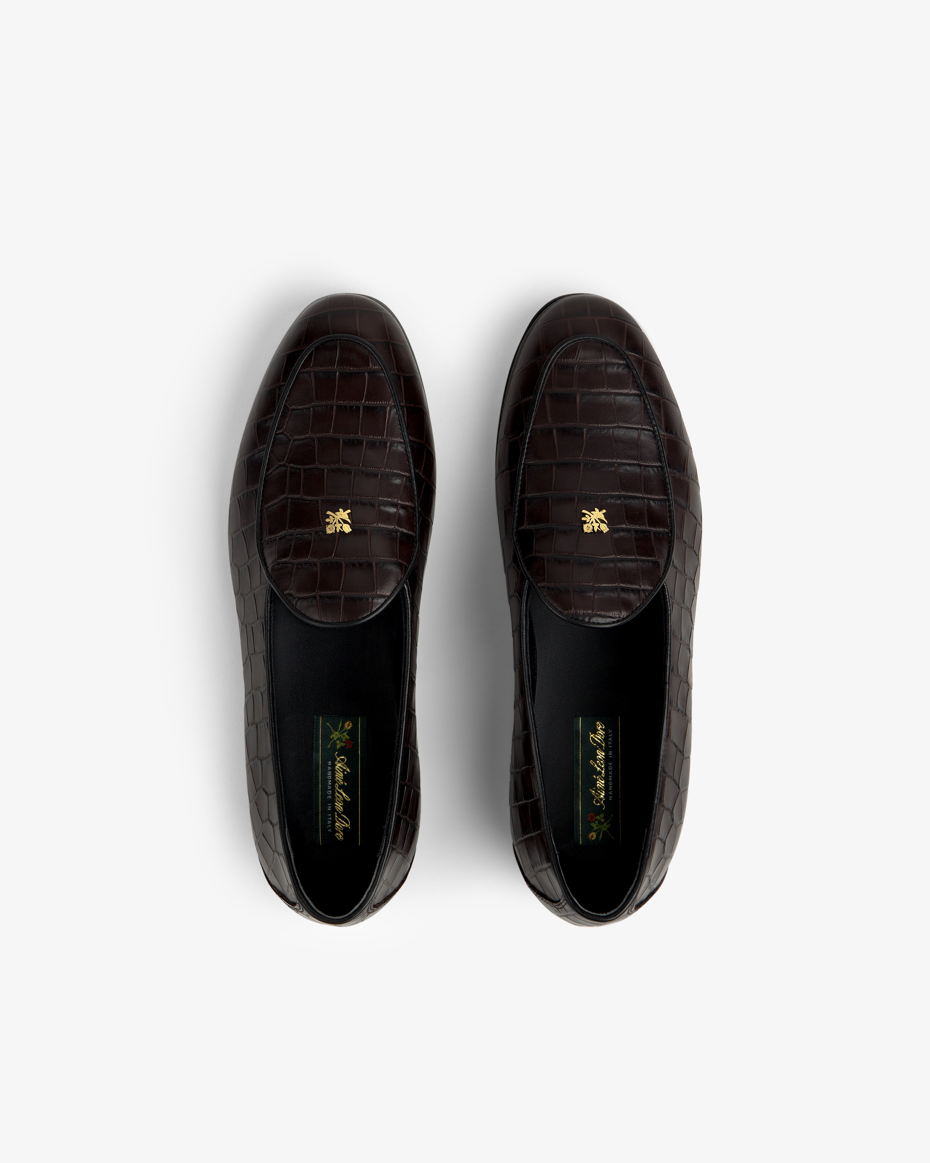 Top view of Croc-Embossed Crest Salóni Loafers in dark brown with gold emblems on the insoles.