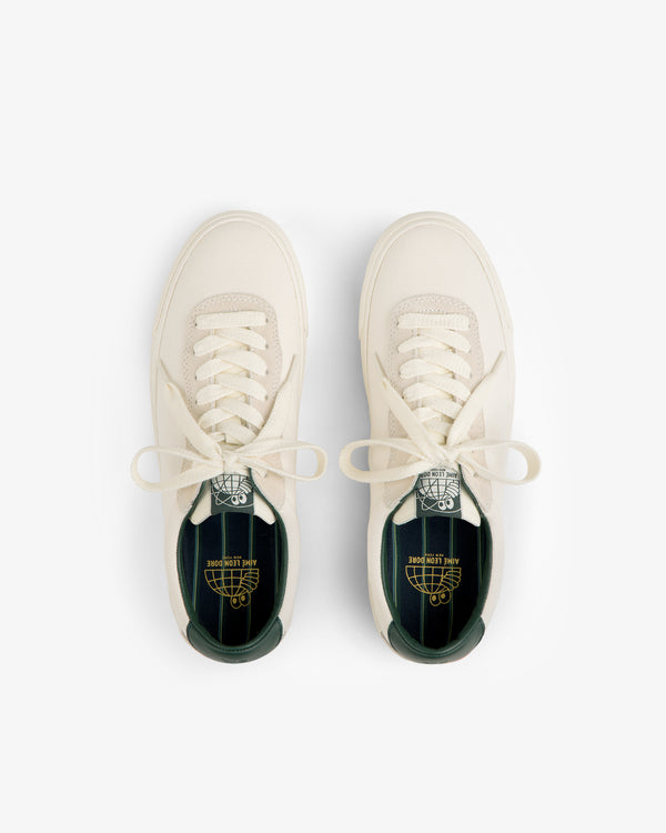 ALD / Last Resort AB VM001-LO Canvas cream sneakers with white laces and green insoles, top view on white.
