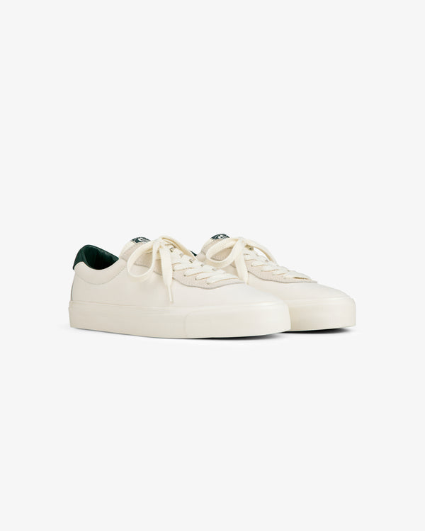 ALD / Last Resort AB VM001-LO Canvas: off-white low-tops with white laces, dark green lining, on a white background.