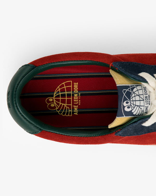 ALD / Last Resort AB VM001-LO Suede sneaker in red, green, and navy with gold Aimé Leon Dore branding on the insole.