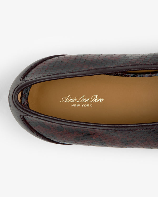 Top-down view of a dark Snake Print Leather Ballet Flat with a tan insole printed with the brand name.