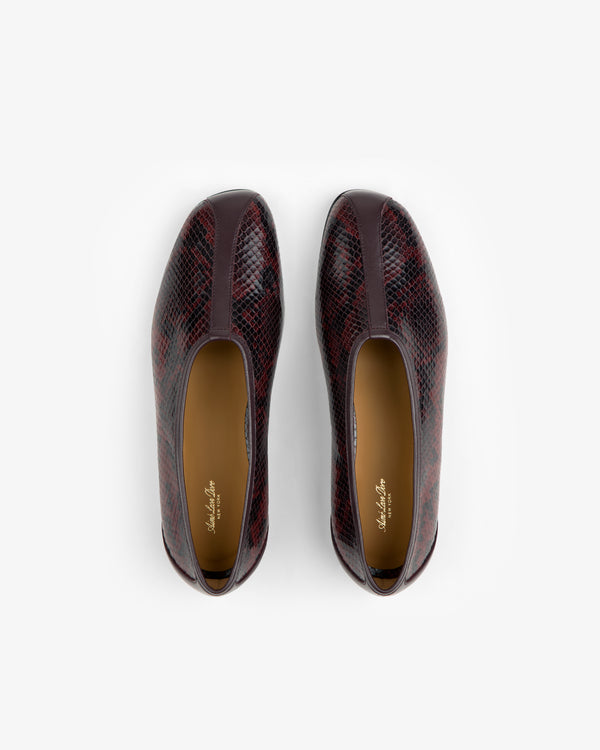 A pair of dark red and black Snake Print Leather Ballet Flat shoes viewed from above.