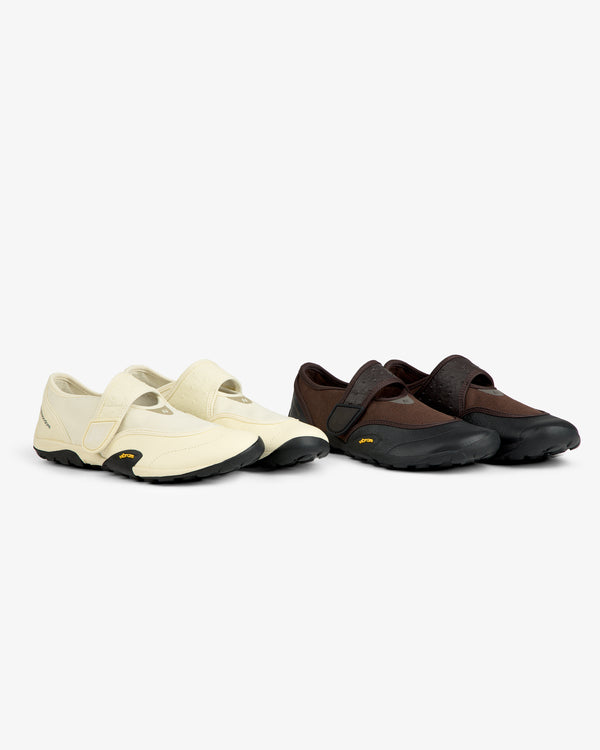 Two pairs of ALD / New Balance MT2 athletic shoes: cream and brown, low-profile, velcro straps, black rubber soles.