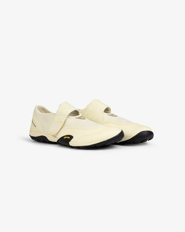 Off-white ALD / New Balance MT2 slip-on shoe with a hook-and-loop strap and a black lugged sole.