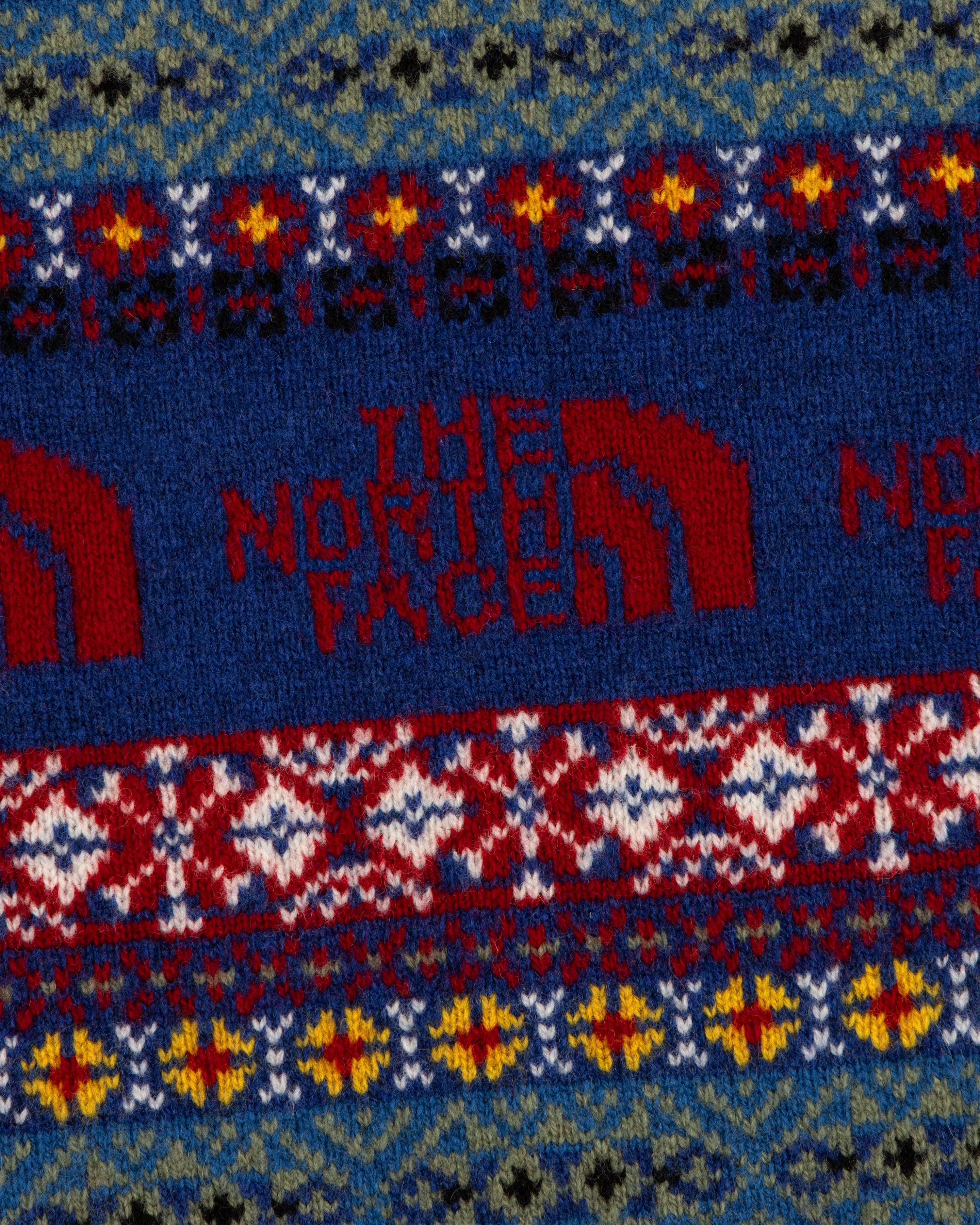 ALD / The North Face Fair Isle Knit Polo with logo and vibrant red, blue, yellow, and green geometric patterns.