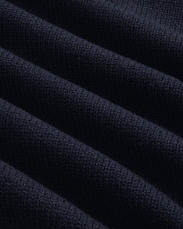 Close-up of Regatta Embroidered Crewneck Sweater: navy ribbed knit fabric with diagonal, wavy-textured folds.