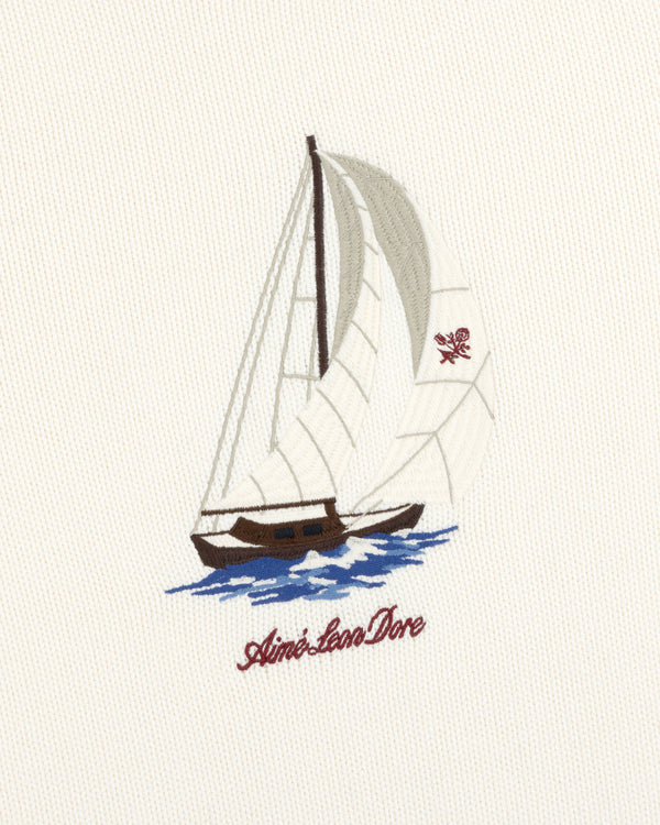Regatta Embroidered Crewneck Sweater with a sailboat design and Aimé Leon Dore in red script underneath.
